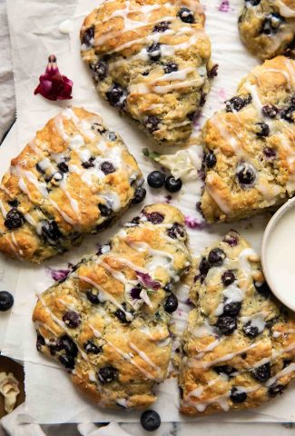 Top shot of Maple Blueberry Scones on a baking sheet with parchment paper.