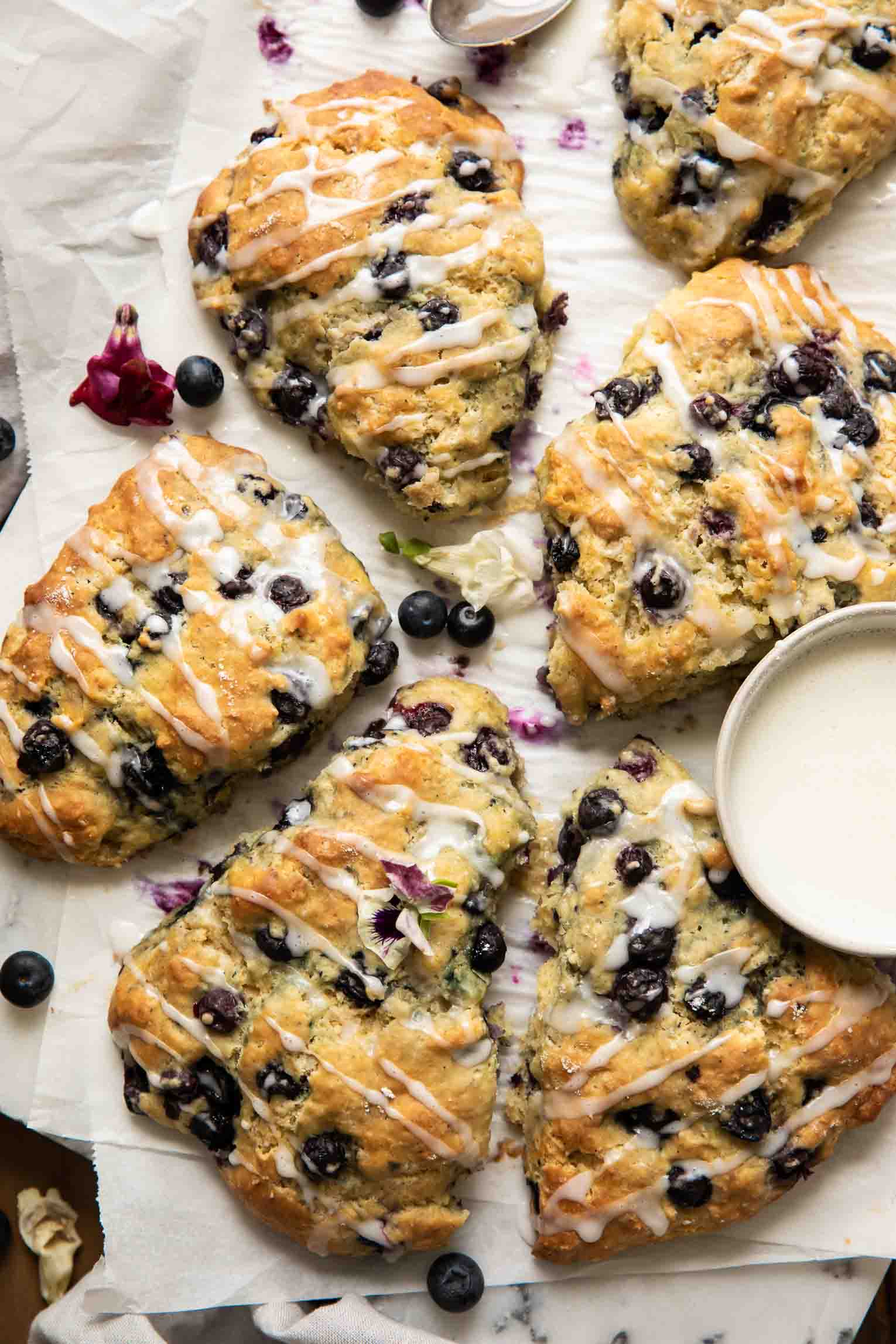 Picture of 5 Maple Blueberry Scones on a baking sheet with parchment paper.