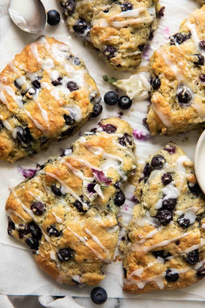 Close up of blueberry scone with icing drizzle.