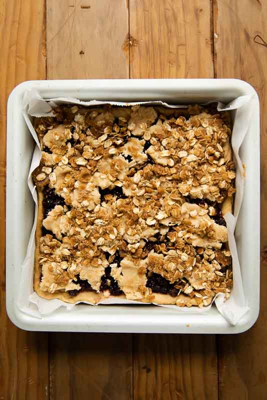 Mulberry pie in a square baking pan with crumble oat topping.