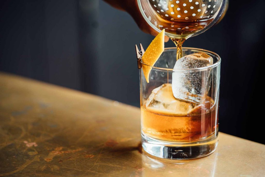 Old Fashioned being poured into a glass.