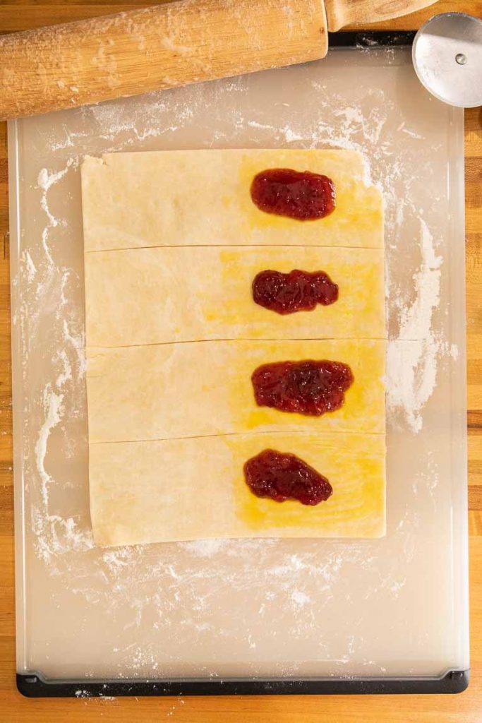 Pastry dough cut into strips with jam.