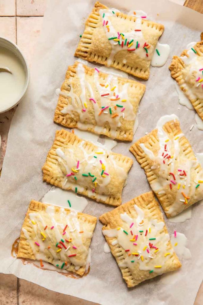 Freshly baked pop tarts with icing and sprinkles.