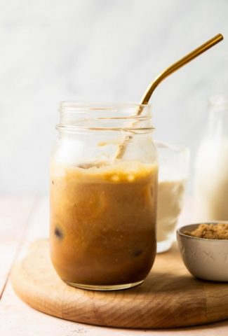 Iced Brown Sugar Oatmilk Shaken Espresso in a mason jar with a metal straw.