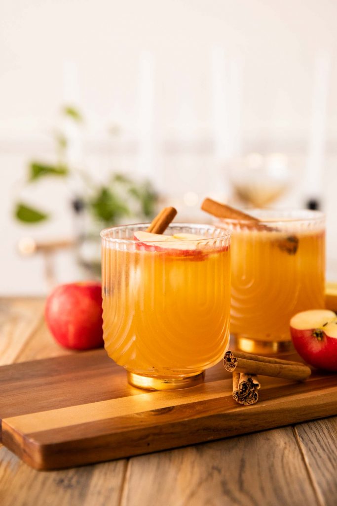 Across shot of Apple Cider Bourbon Cocktail on a wooden board.