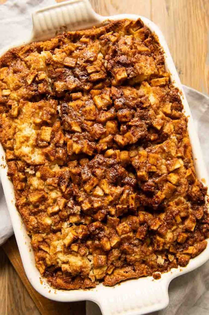Baked apple fritter cake in a pan.