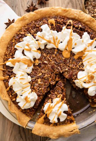 Top shot of the best Butterscotch Pecan Pie recipe with whipped cream and butterscotch drizzle.