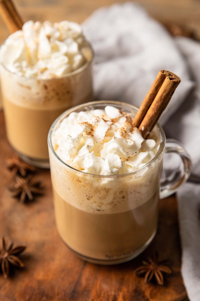 Homemade eggnog latte recipe in two mugs with whipped cream.