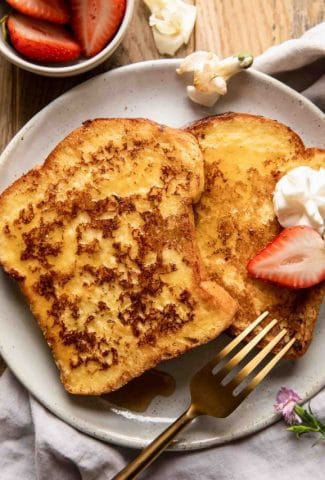 Top shot of Buttermilk French Toast on a plate with whipped cream.