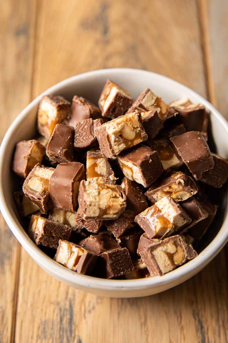 Bowl of chopped snickers pieces.