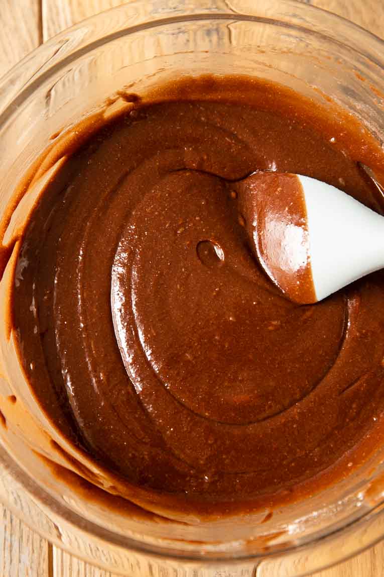 Chocolate brownie batter being mixed together.