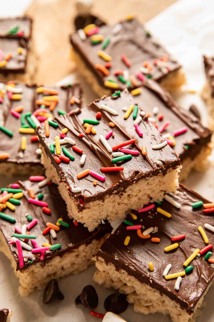 Angled photo of stacked Chocolate Covered Rice Krispies Treats.