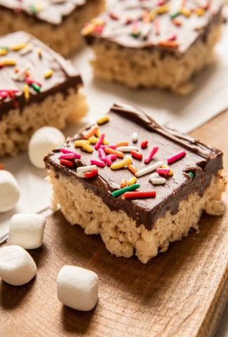 Angled photo of Rice Krispie Treat covered in chocolate and sprinkles.
