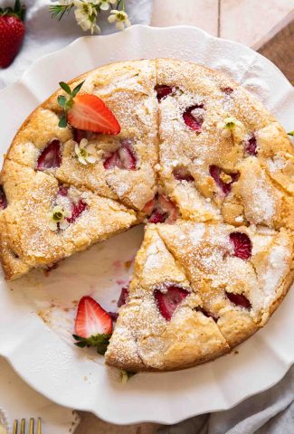 The BEST French Strawberry cake cut into slices.