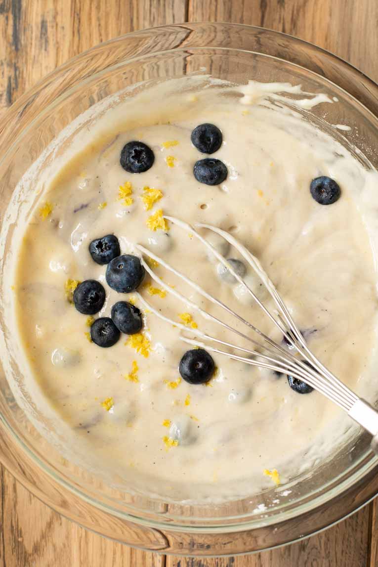Lemon blueberry pancake batter in a mixing bowl.