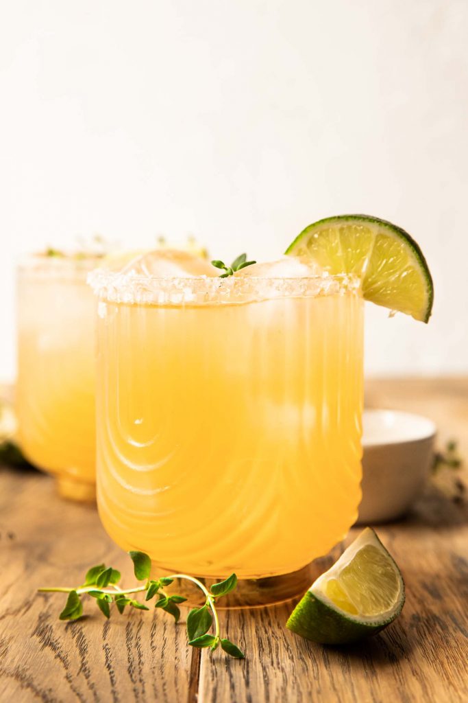 Classic rum margarita recipe in a glass with a lime wedge.