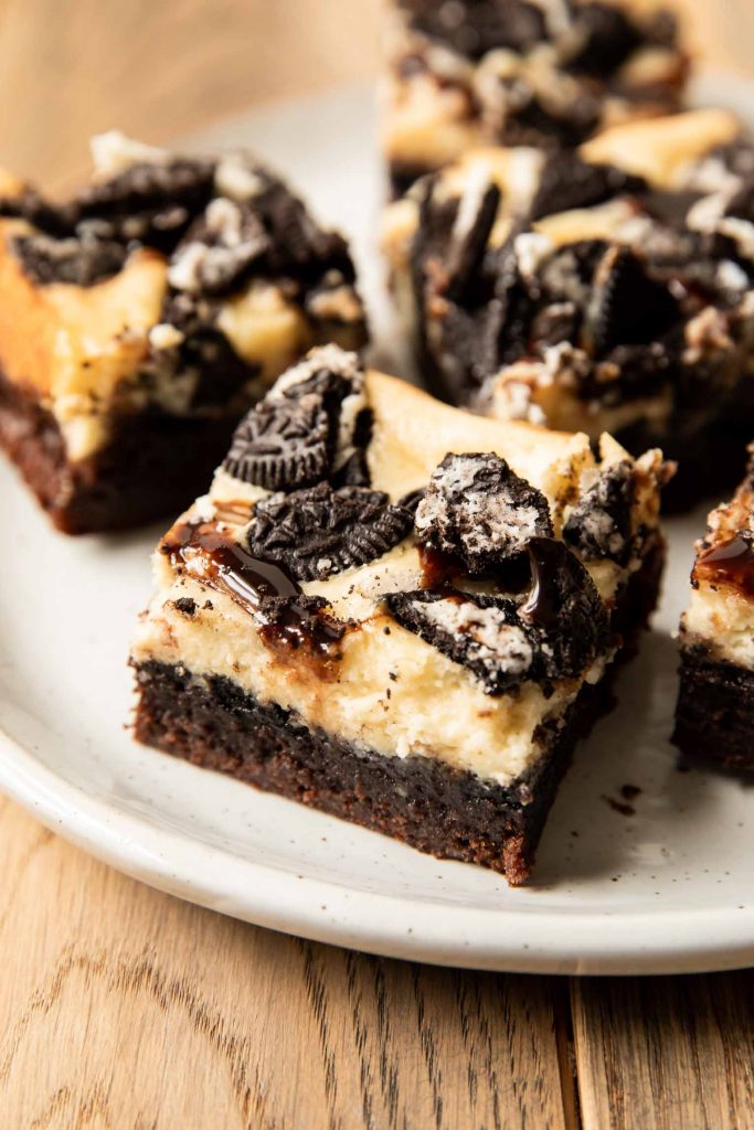 Angled photo close up of cheesecake brownie with Oreos.
