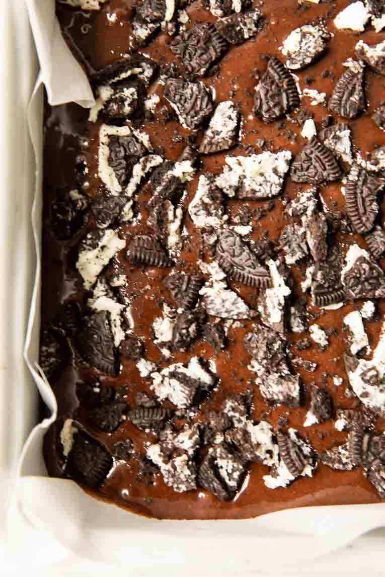 Oreo brownie batter in a baking pan.