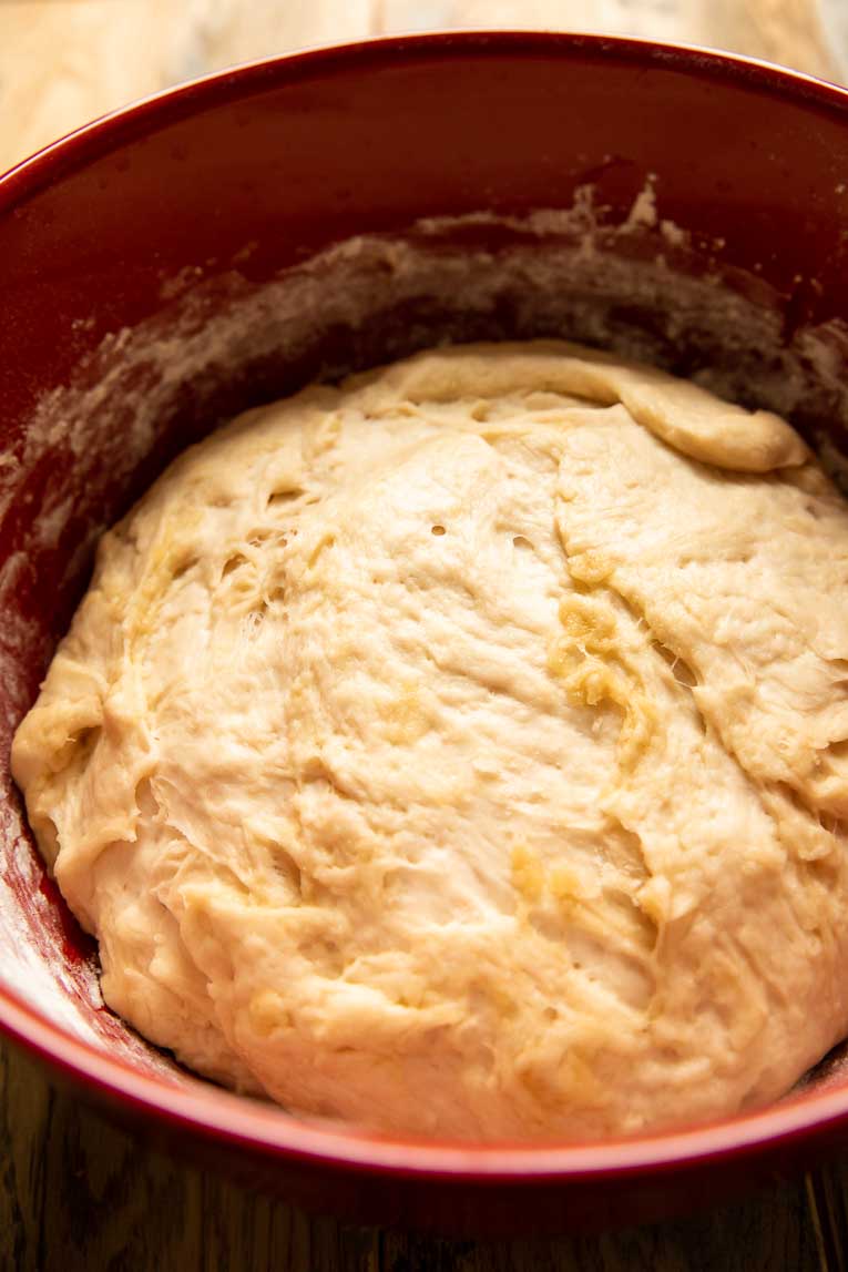 Cinnamon roll dough in a mixing bowl.