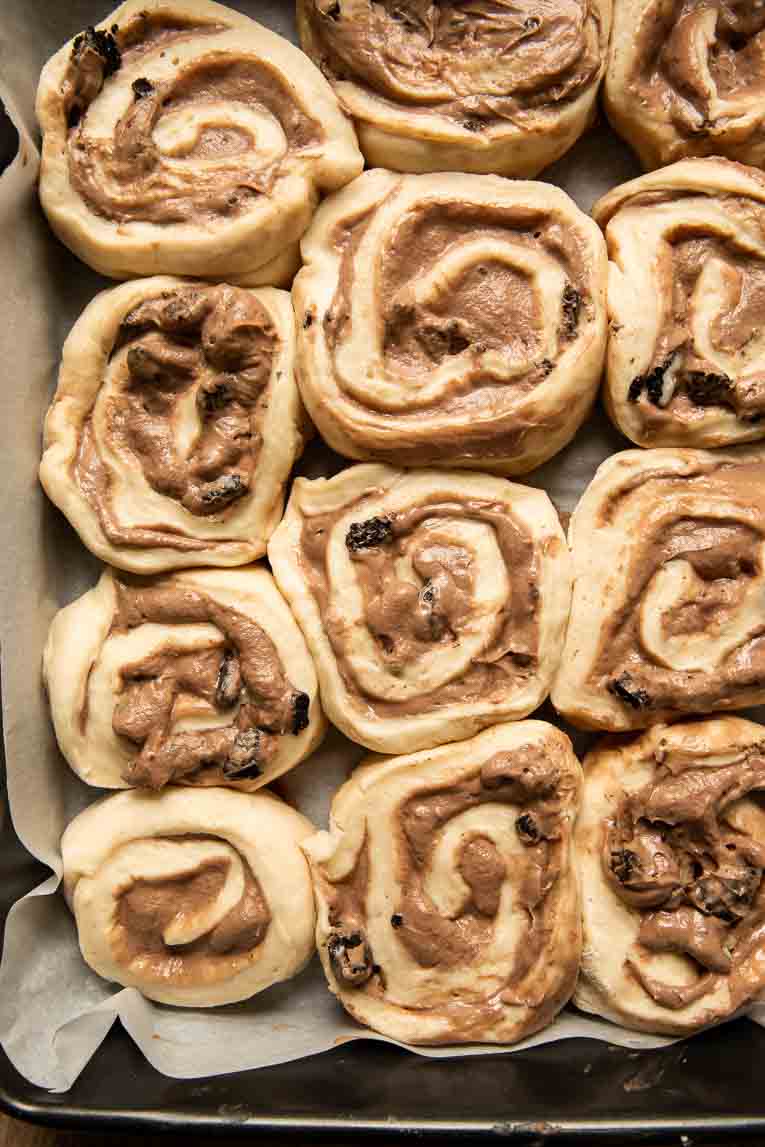 Cookies & Cream Cinnamon Rolls rising in a pan.