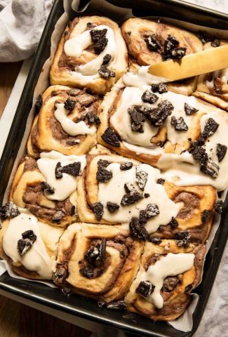 Cookies & Cream Cinnamon Rolls in a pan with icing.