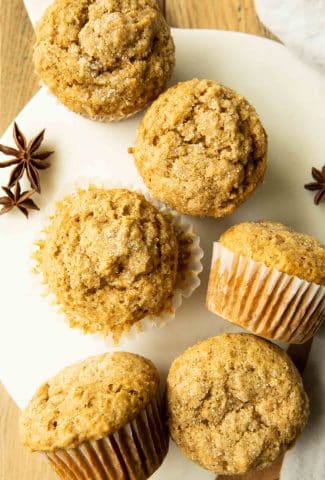 Top photo of apple cider muffins on a serving board with star anise.