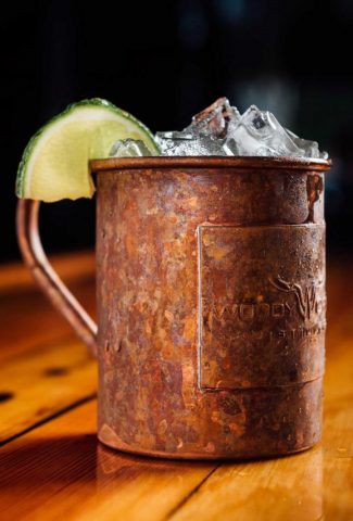 Antique copper mug with Moscow mule cocktail.