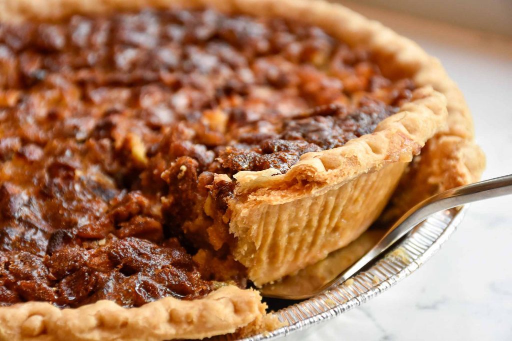 Pecan pie slice being removed.