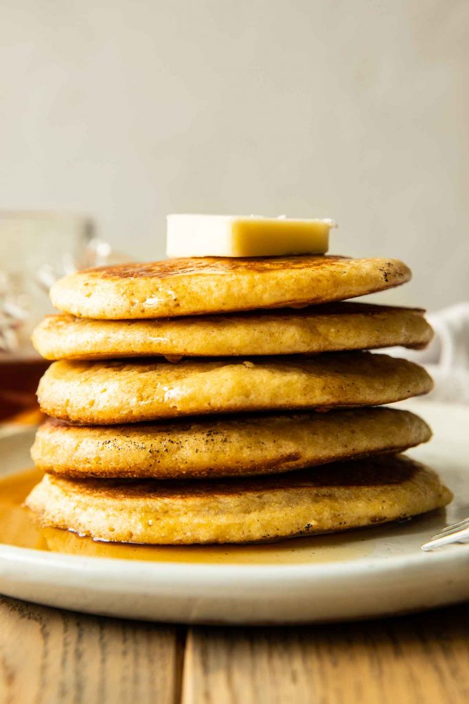 Cornbread pancakes recipe with butter on a plate.