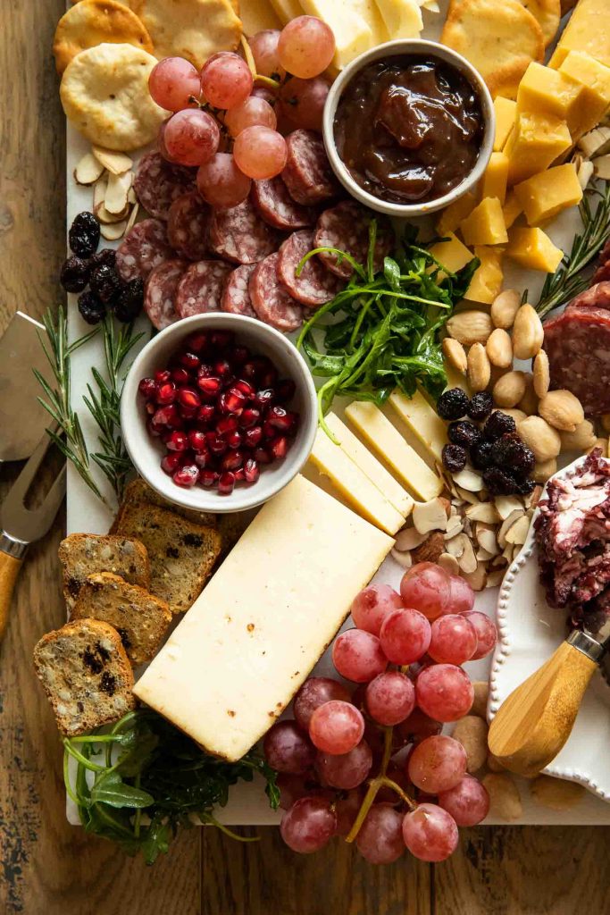 Close up of cheese and meat on a charcuterie board.