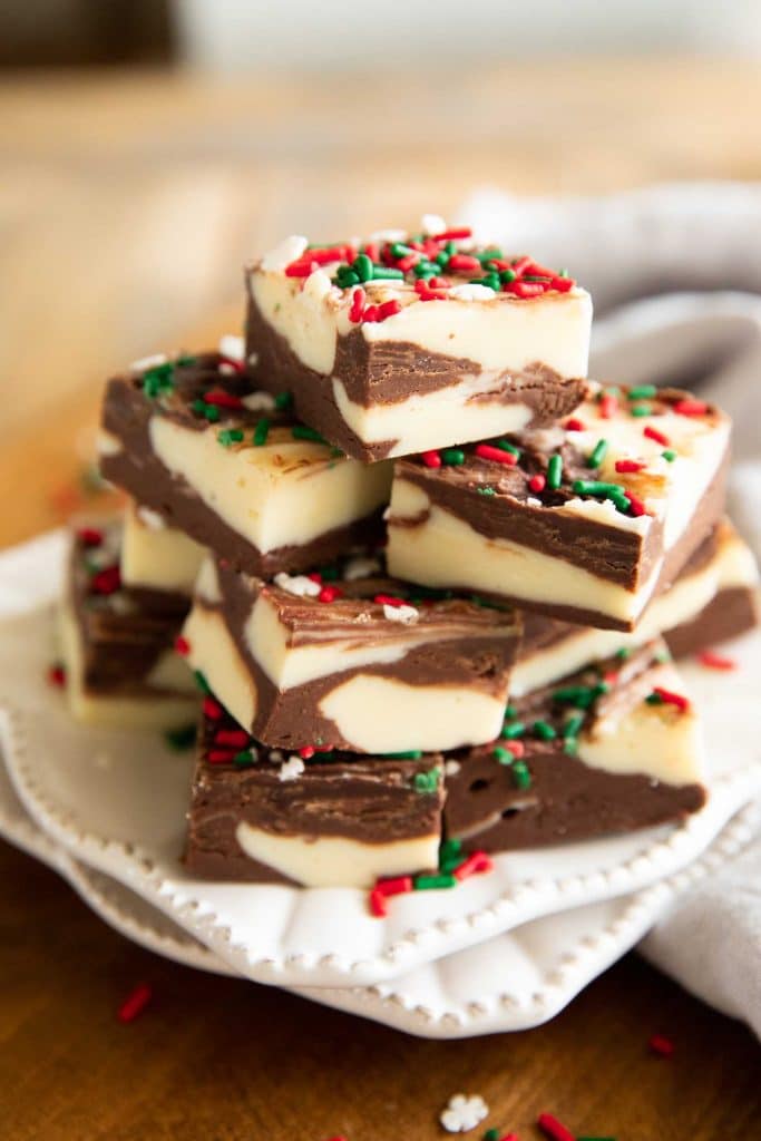 Angled photo of Christmas Cookie Fudge on a white plate.