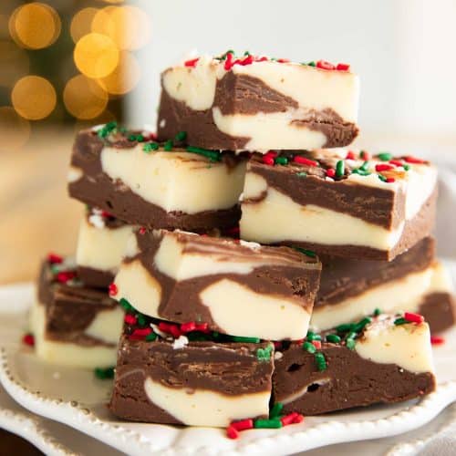 Christmas Cookie Fudge with sprinkles on a plate.