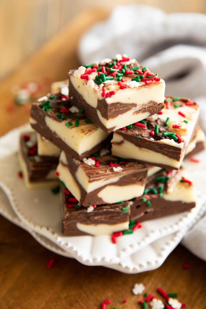 Angled photo of Christmas Cookie Fudge recipe with white chocolate and sprinkles.