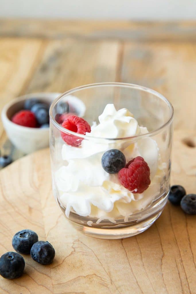 Mascarpone Whipped Cream with berries in a cup.