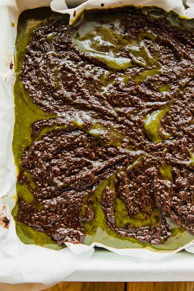 Matcha brownie batter mixed in a baking dish.