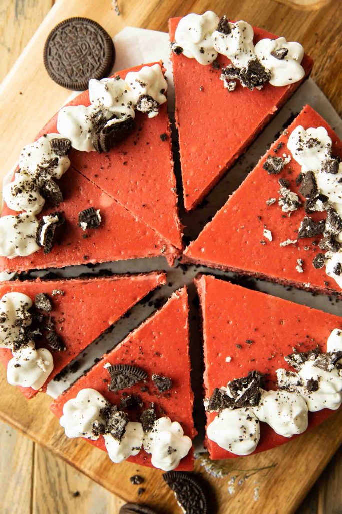 Red Velvet Oreo Cheesecake with whipped cream and cookies.