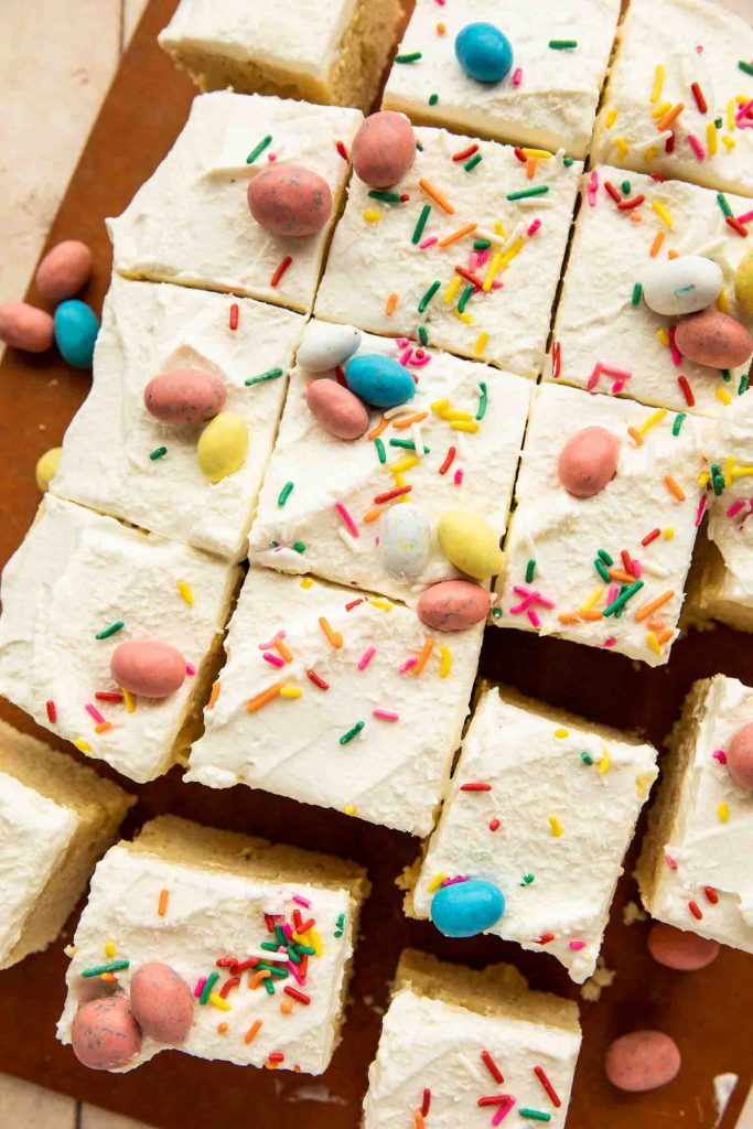 Easter Poke cake slices on a cutting board.