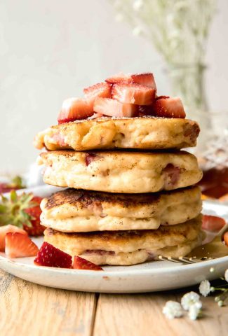 Strawberry Pancakes stacked on a plate.