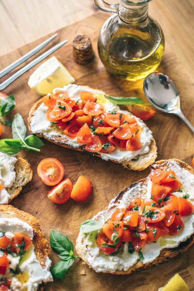 Ricotta cheese on toast with tomatoes.