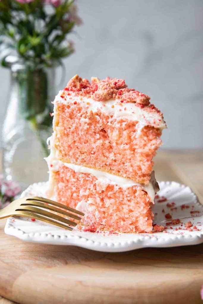 Strawberry crunch cake on a white plate.