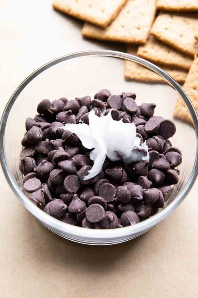 Chocolate chips with coconut oil in a microwave safe dish.