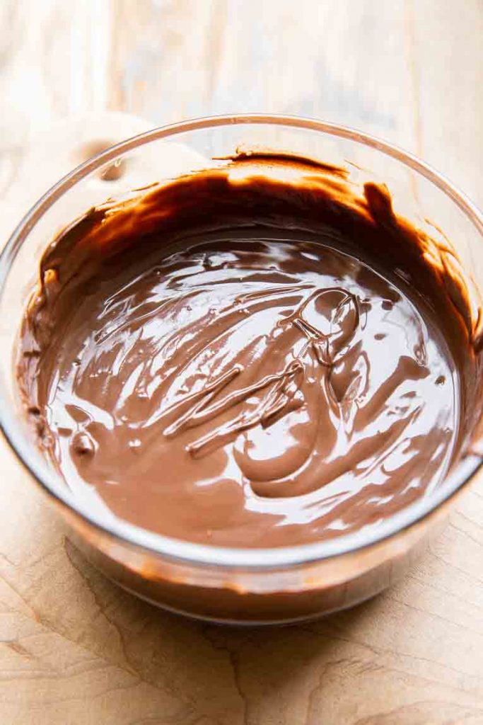 Melted dark chocolate in a bowl.