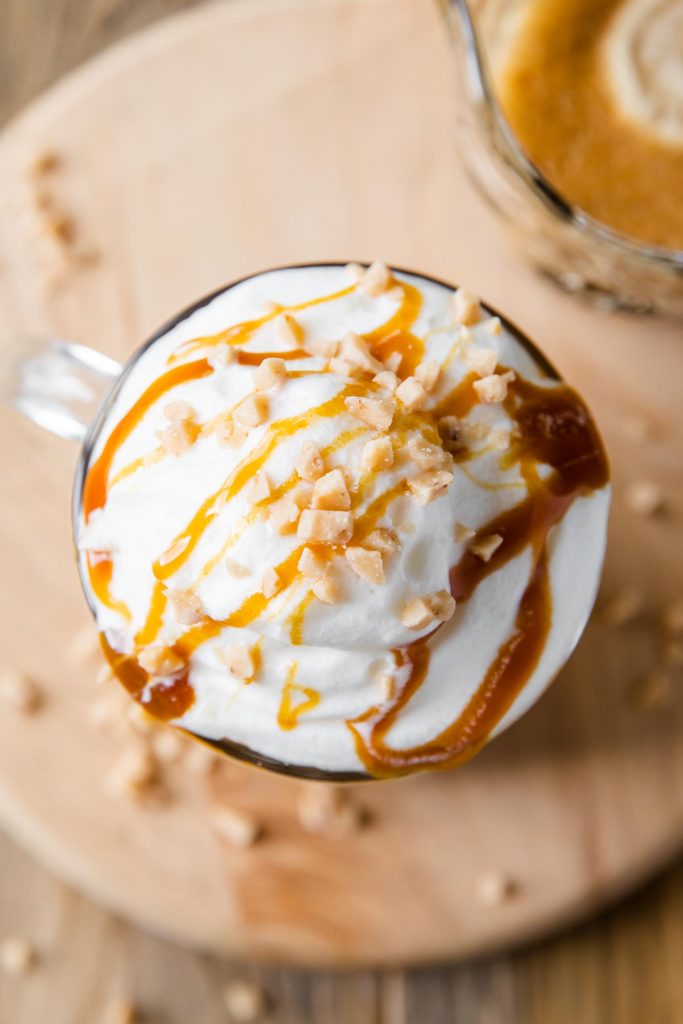 Latte with whipped cream, caramel syrup, and brûlée bits.
