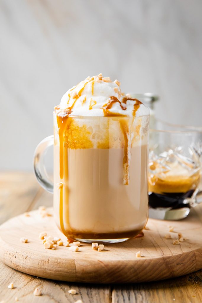 Caramel Brûlée Latte recipe Starbucks copycat in a mug with whipped cream and caramel.