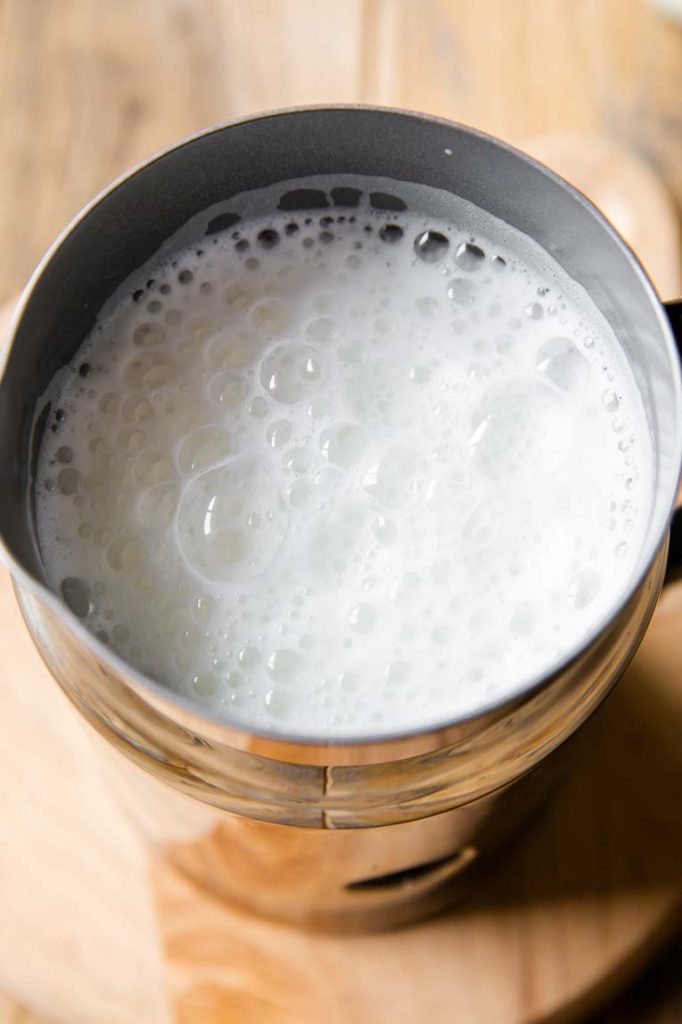 Milk being steamed in a milk frother.