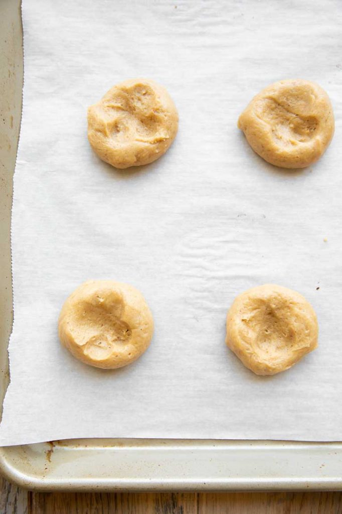 Pumpkin cookie dough on a baking sheet.