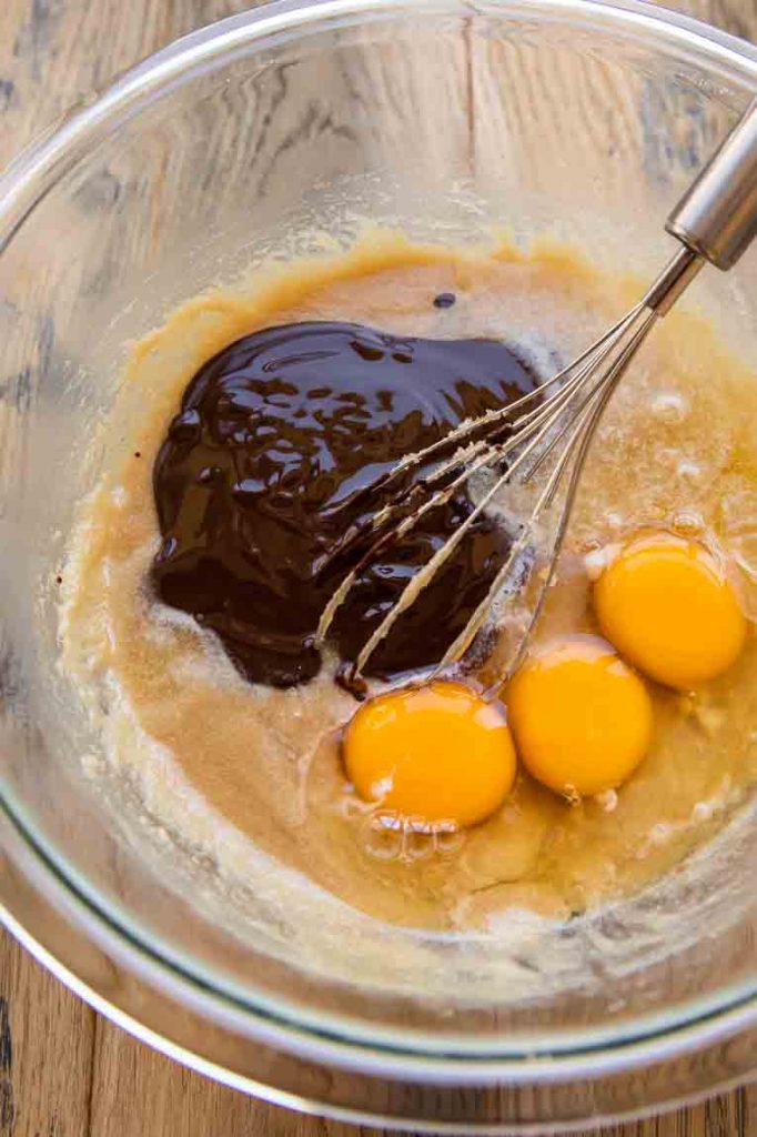 Eggs and melted chocolate mixed with liquid ingredients.