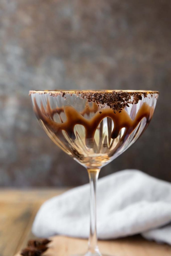 Coupe glass with chocolate drizzle and chocolate glass rim.