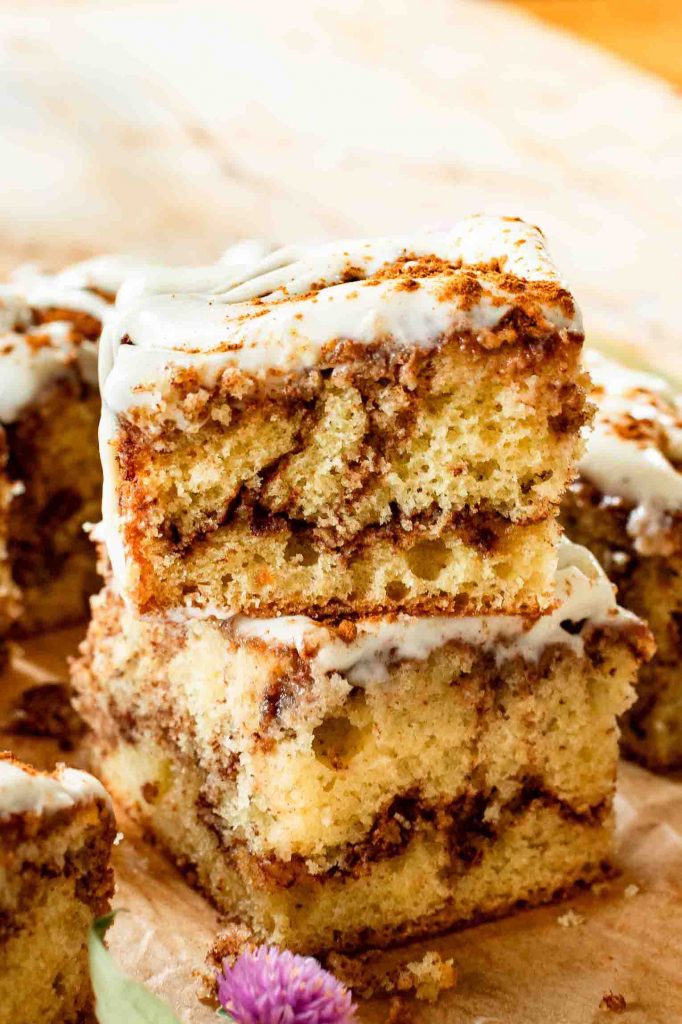 Snickerdoodle Cake slices stacked with cream cheese icing.