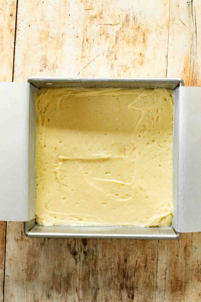 Cake batter in a square cake pan.